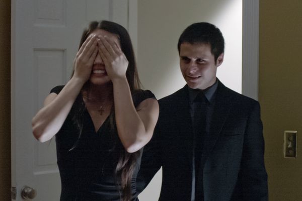 Matt taking Linda to her surprise while she covers her eyes.