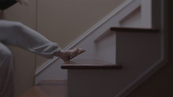 A woman falls down the stairs.