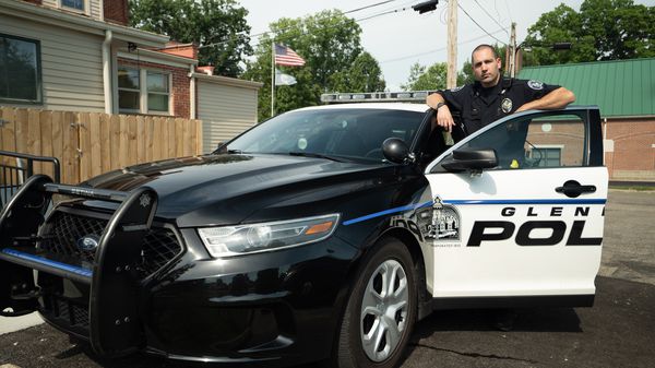 Officer Josh Hilling with police squad car.