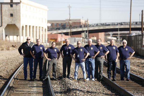 Cold Case Task Force group photo on train tracks.