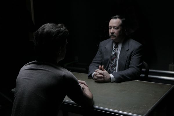 A detective interviews a suspect.